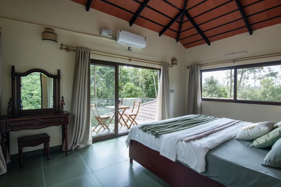 Bedroom with a dresser and doors to the balcony