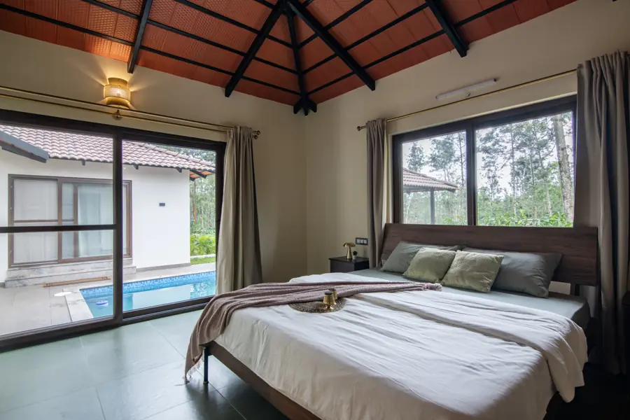 Bedroom with a sliding glass door opening onto the pool