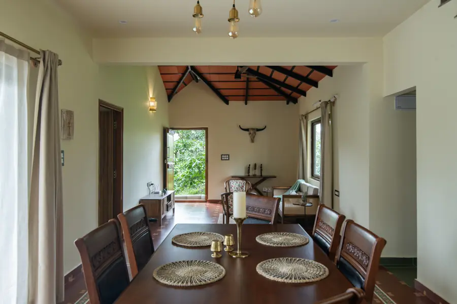 Dining table under a timber-raftered ceiling