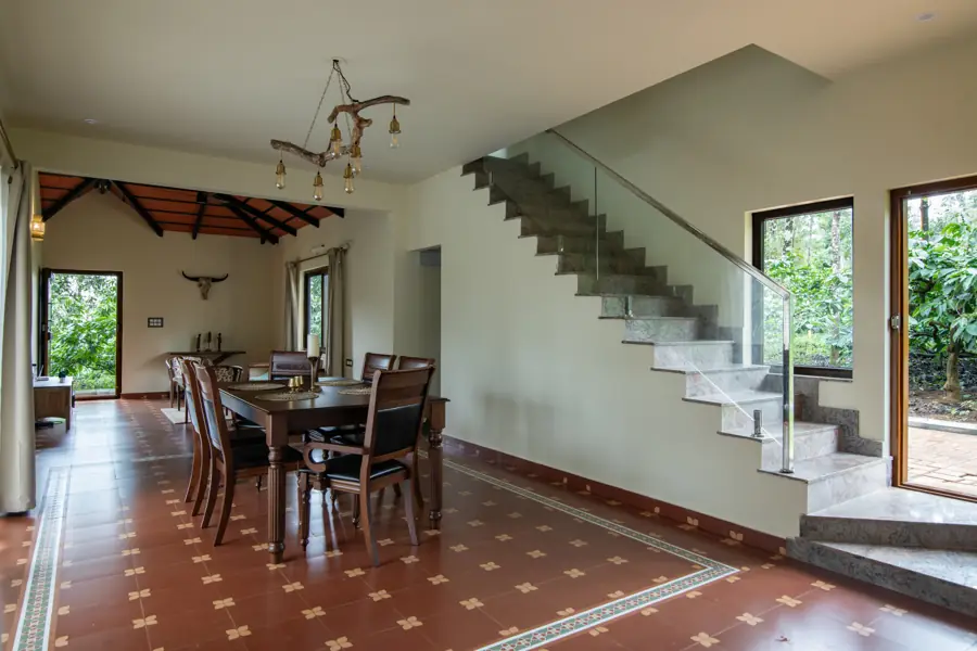 Dining room with a wooden table beside the staircase