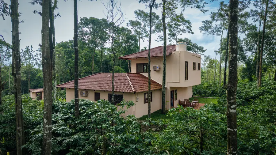 The villa among coffee plants and tall trees by day