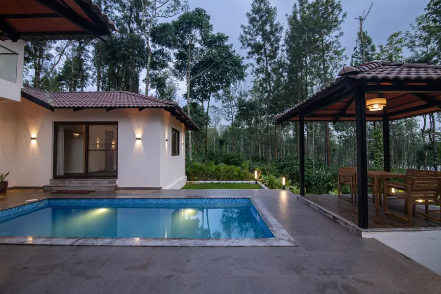 Pool and gazebo with lights on in the evening