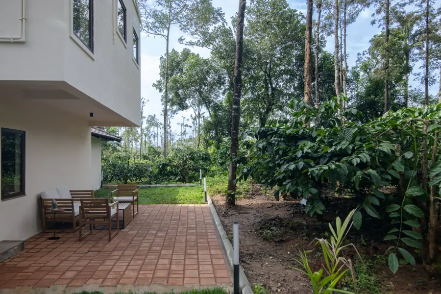 Sit-out with chairs and a table beside the lawn